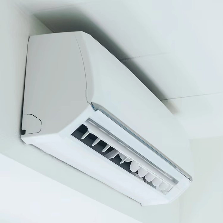Close-up of a white ductless mini-split AC unit mounted on the wall